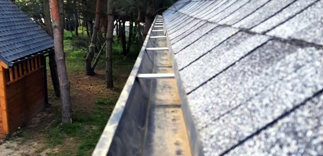 Eavestrough cleaning and debris removal on a residential property